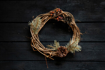 new year christmas wreath on an old wooden table, decor for the holiday, vine wreath