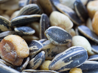 Salted pipes, kikos, peanuts and sunflower seeds up close, are processed foods with lots of additives and colorants. Healthy eating concept