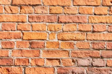 Old brown brick wall. Background with red bricks and layers of cement.