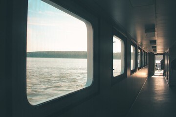 Ferry corridor, square windows, light falls on the floor. Transit from Klaipeda to the Curonian Spit