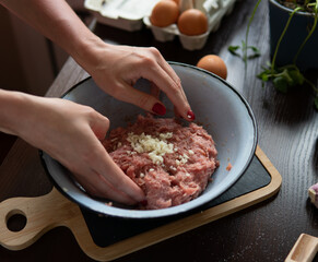 Turkey meatballs baked in the oven with herbs made by a girl according to a recipe from the Internet