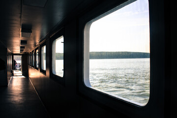 Fototapeta na wymiar Ferry corridor, square windows, light falls on the floor. Transit from Klaipeda to the Curonian Spit