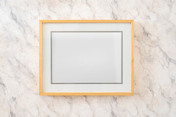 Home decoration, empty wooden picture frames, poster, blank canvas, mock up, on a marble wall, living room, template front view