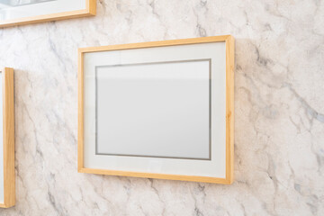 Home decoration, empty wooden picture frames, poster, blank canvas, mock up, on a marble wall,...