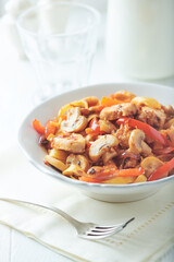 Pappardelle Pasta with chicken breast, red pepper and champignons. Bright background. Close up. 