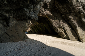 Cliffs and beach seen through the Arches, Doctors Point, Dunedin, New Zealand
