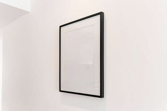 Home Decoration, Empty Black Frame, Poster, White Canvas, Mock Up On A White Wall, Living Room, Template Angle View