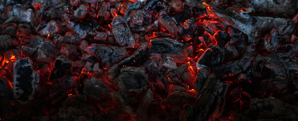 Burning coals in the dark, smoldering coal. Bright red sparks of fire. Background. - obrazy, fototapety, plakaty