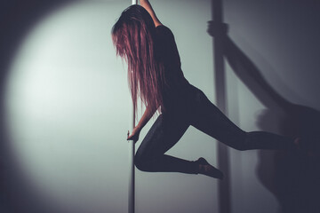 Fototapeta na wymiar young asian woman doing pole dance at home