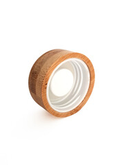 Close up of round wooden screw cap for bottle. Front view of inside of wooden plug. Isolated bottle lid. Ecological and biodegradable utensils and accessories.