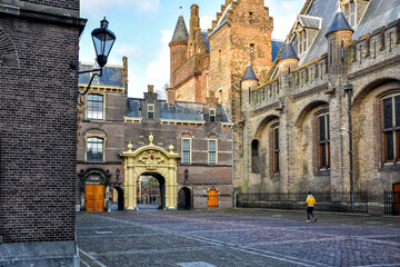 A hiker leaves the courtyard via the Mauritspoort a building complex in the center of The Hague,...