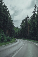 a forest high-mountain road and cloudy sky, South Ural mountains