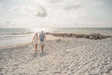 holding hands along the beach