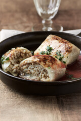 Stuffed cabbage rolls - popular Polish dish on rustic wooden background. Close up. 