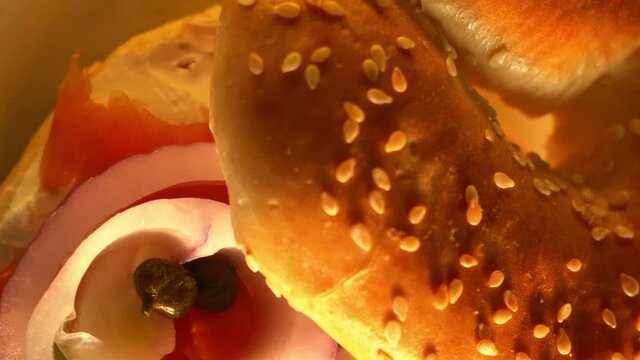 Bagel with cream cheese salmon onion and capers rotating under orbiting camera