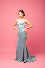woman in silk dress. Full length studio portrait of young beautiful woman in long gray silk dress...