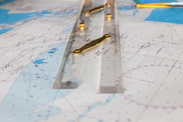 Maps of the ship and on them a ruler and divider for plotting the course. - obrazy, fototapety, plakaty