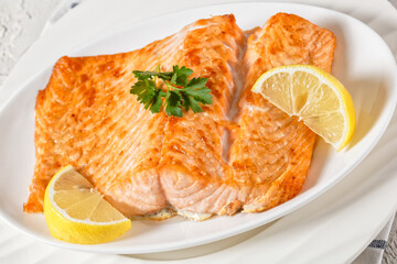 grilled salmon fillet on a white platter