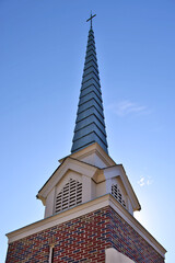 Closeup of brick traditional church steeple and cross - obrazy, fototapety, plakaty