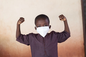 Strong and proud African child posing with face mask and showing strenght!