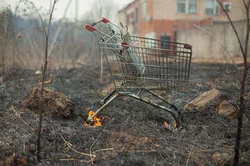 The supermarket cart is on fire. A grocery basket caught fire in the street.