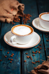 Cups of coffee on a rustic wooden background
