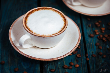 Cups of coffee on a rustic wooden background