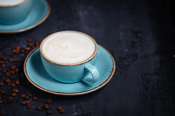 Cups of coffee on a rustic wooden background