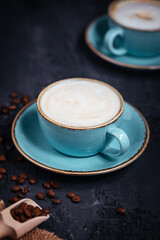 Cups of coffee on a rustic wooden background