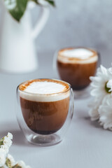 Cups of coffee on a rustic wooden background
