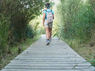 Caucasian girl on field trip on wooden path