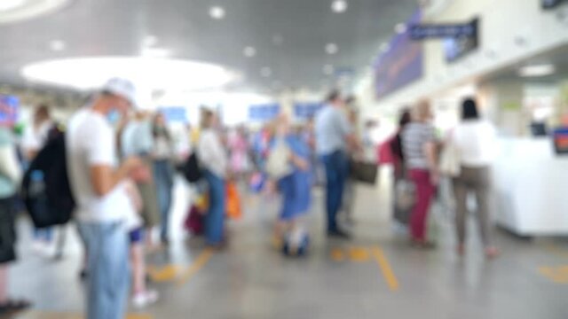 People wearing medical protective masks in airport terminal. New normal travel during covid-19 pandemic situation in the world. Blurred footage