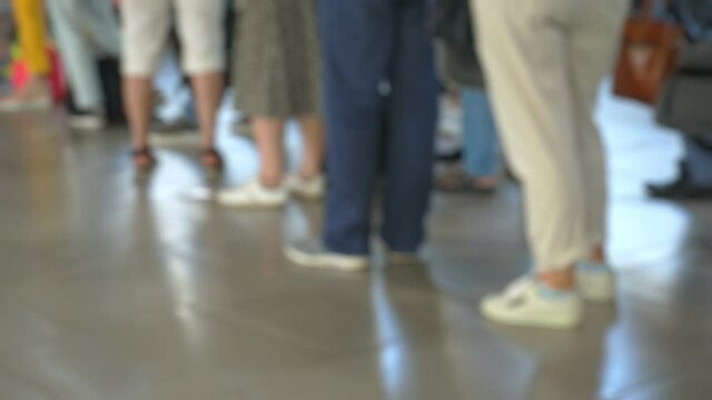 People standing in check-in queue at airport terminal and waiting for the flight. Blurred footage