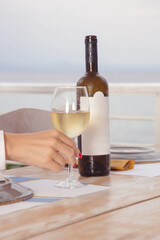 White wine glass and bottle on the restaurant table