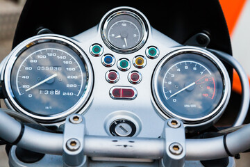 Dashboard of a sports motorcycle, with speedometer and tachometer, close up.