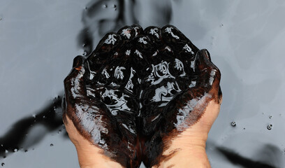 hands in crude black petroleum - obrazy, fototapety, plakaty