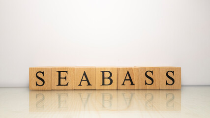 The name Seabass was created from wooden letter cubes. Seafood and food.