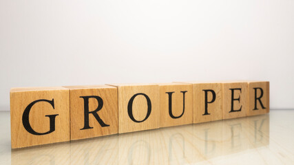 The name Grouper was created from wooden letter cubes. Seafood and food.