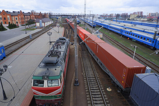 Passenger train parked at the train station top view. Locomotive and freight train.