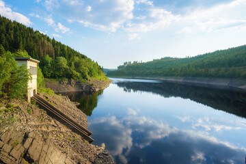 Panorama view of a dam in Germany in summer with blue sky an