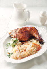 Spicy roasted chicken leg with mashed potatoes and raw salad. Bright background. Close up. 