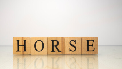 The name Horse was created from wooden letter cubes. Words and animals.