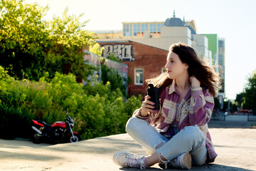 Fototapeta premium A young happy girl on the street in the city