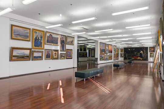 Art gallery interior. Old paintings hang in the museum.	