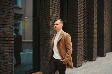 Portrait of an attractive young businessman in urban background wearing suit a necktie.