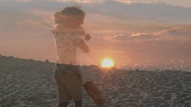 Animation of romantic african american couple hugging at beach over sunset