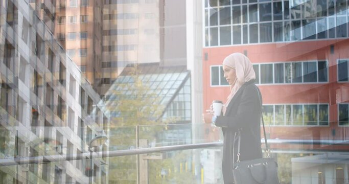 Animation of asian woman in hijab using smartwatch over cityscape