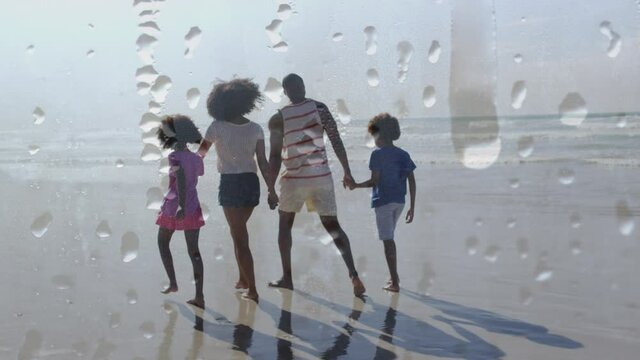 Animation of happy african american family walking at beach holding hands over droplets