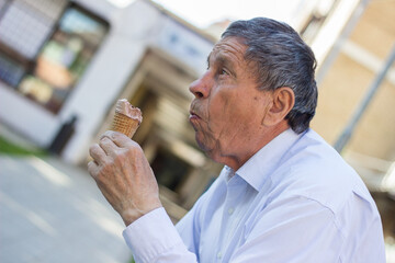 Happy senior Man eating ice cream	