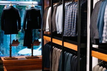 Pants in men's hands in a clothing store, close-up.